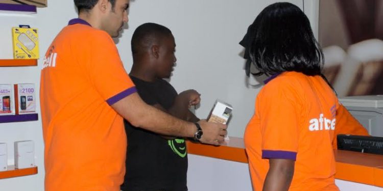 Africell's Commercial Director,  Milad Khairallah (L) and other Africell staff.