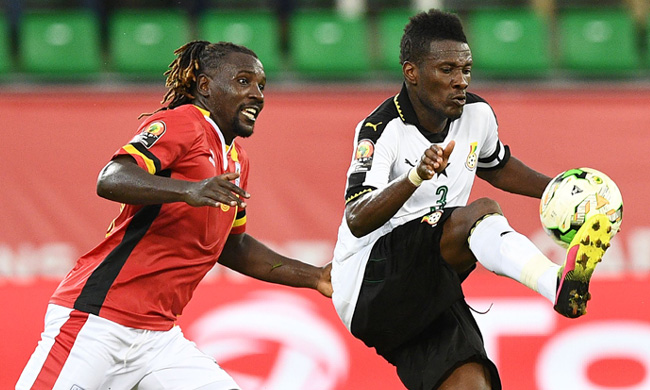 Hassan Waswa tussling it out with Asamoah Gyan in Cranes AFCON opener