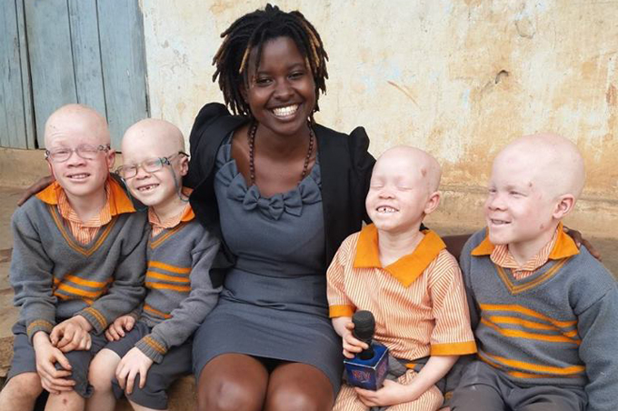 Uwitware is known for her compelling everyday people stories. In the photo she was with albino school children.