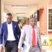 Alex Esagala with his lawyer the day he filed the suit at High Court in Kampala. COURTESY PHOTO.