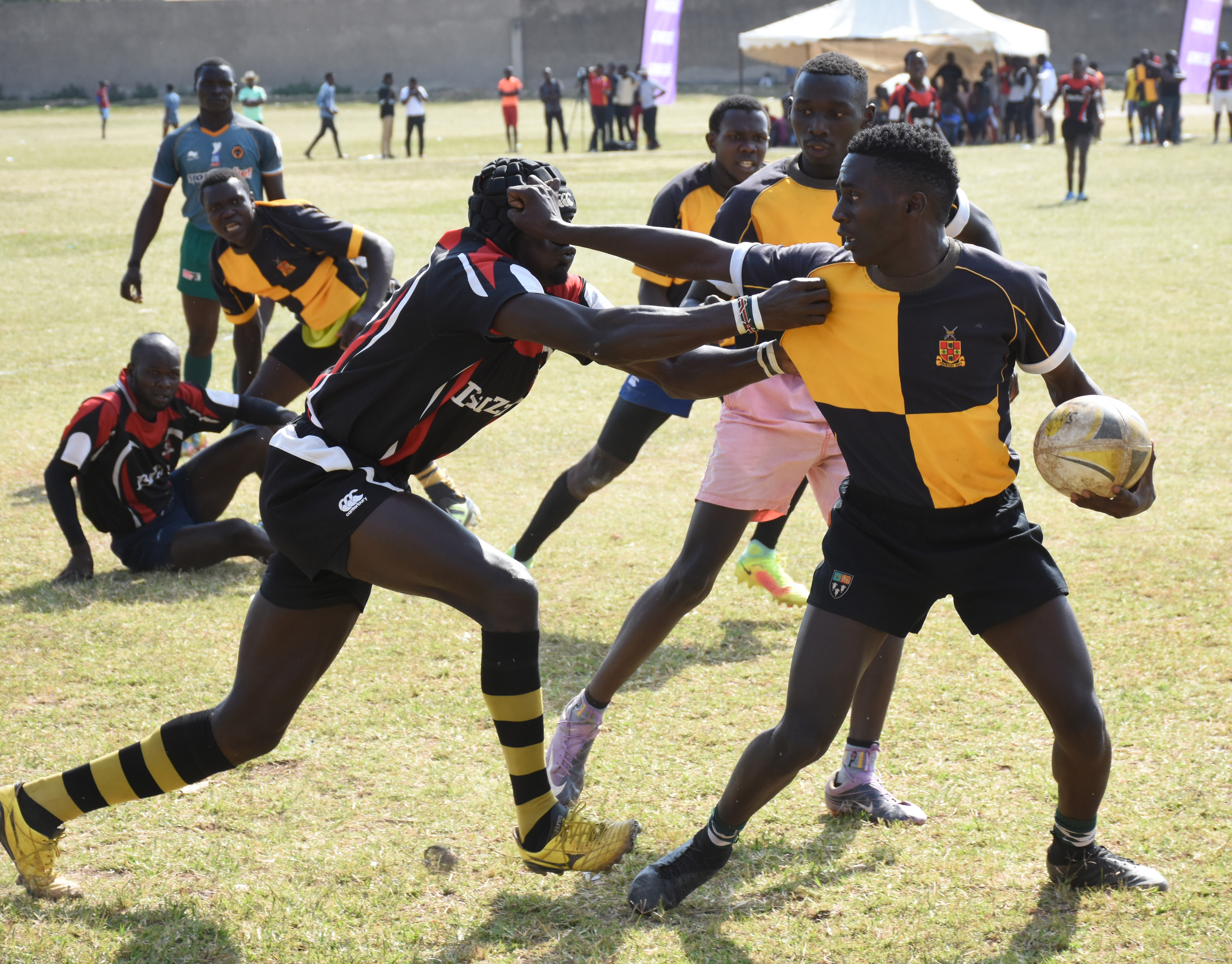Stallion player in yellow and black hands off Pirates' Richard Odokere  during their game during thre Guinness 7s. Pirateswon 14-12. PHOTO BY JOHNSON WERE