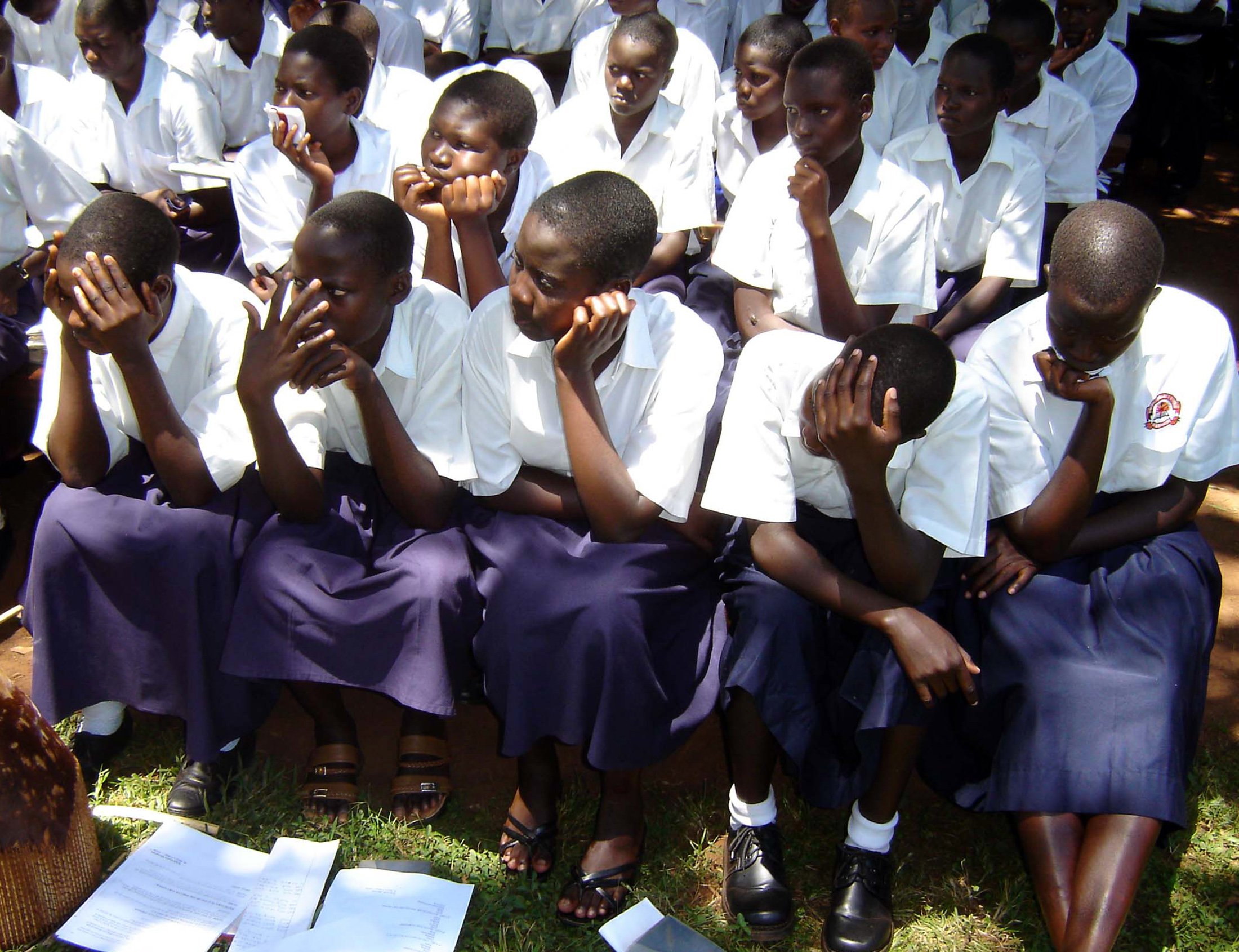 Ugandan students from St. Mary's College in Aboke listen as former abducted girls who returned from captivity by Lord's Resistance Army (LRA) rebels talk about their ordeal during a ceremony October 10, 2005 to commemorate the abduction day . Nine years ago LRA rebels abducted 139 students of St. Mary?s College in Aboke, releasing 109 students when the school?s deputy headmistress Rachele Fassera, an Italian nun, followed the rebels into the bush but retained 30 girls, most of them aged between 14 and 15 years. Twenty-four of the girls have since returned at different times and five are believed to have died. The fate of one is not yet known. Picture taken October 10, 2005. REUTERS/Hudson Apunyo - RTR196Y8